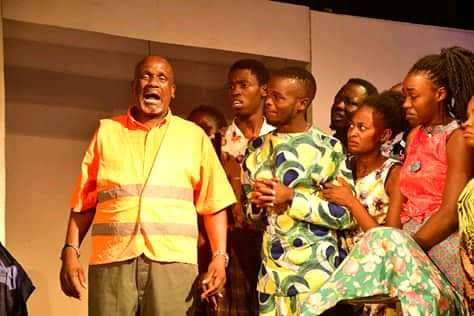 Phillip Luswata with a chorus/ group cast in the 2019 production